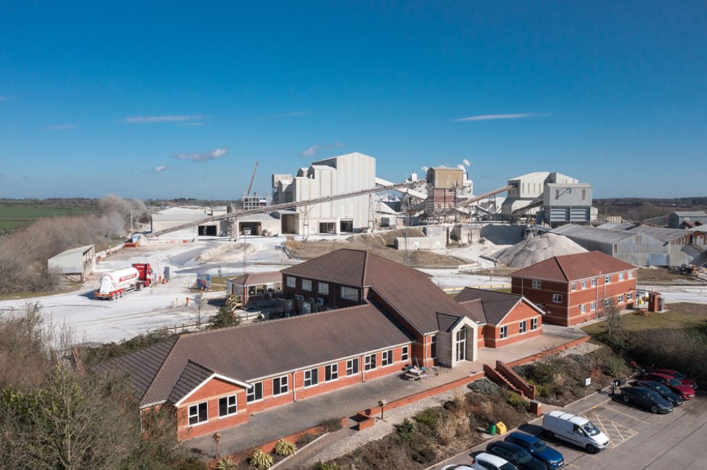 A bird's eye view of part of Singleton Birch operations, with a brick office building in the foreground and lime kilns and silos in the background